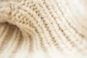 Closeup beige gestrickter Wollstoff Hintergrund foto