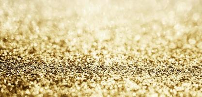 abstraktes goldglitter funkeln mit bokeh hintergrund foto