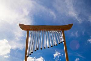 windmusikalische Glockenspiele auf dem Hintergrund des blauen bewölkten Sommerhimmels. foto