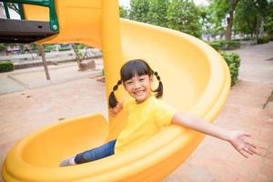 aktives kleines Mädchen auf dem Spielplatz foto