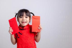 chinesisches babymädchen, das sich traditionell mit einem fu verkleidet, bedeutet glücklichen roten umschlag foto