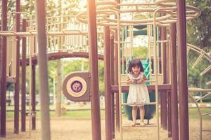 aktives kleines Mädchen auf dem Spielplatz foto