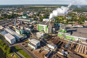 Luftbild auf Rohren des Sägewerks des Holzbearbeitungsunternehmens. Luftverschmutzungskonzept. Industrielandschaft Umweltverschmutzung Abfall foto