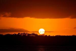 Sonnenuntergang über dem Fluss foto