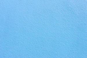 Hellblaue pastellfarbene Zementwand für Taxture und Hintergrund foto