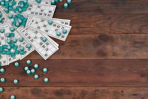 Viele Fässer mit Zahlen und Karten für Lotto oder russisches Bingo-Tischspiel auf Holzoberfläche. Das russische Lotto hat ähnliche Regeln wie das klassische weltweite Bingo foto