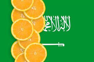 saudi-arabische flagge und zitrusfruchtscheiben vertikale reihe foto