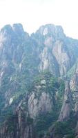 die wunderschönen berglandschaften mit dem grünen wald und der ausgebrochenen felsenklippe als hintergrund in der landschaft des chinas foto