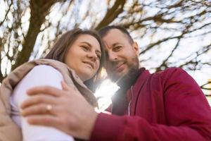 Porträt eines erwachsenen traditionellen Ehepaares mit berührenden Stirnen vor dem Hintergrund eines Herbstbaums foto