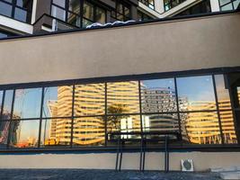 Eingangsgruppe zum Eingang. Glasdekoration des Gebäudes. Panoramafenster, in denen Licht reflektiert wird. Plexiglas. stilvolle Gestaltung der Eingangshalle aus Metall in Braun-Schokolade foto