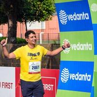 neu delhi, indien - 16. oktober 2022 - vedanta delhi halbmarathonrennen nach covid, bei dem die marathonteilnehmer kurz vor dem überqueren der ziellinie stehen, delhi halbmarathon 2022 foto