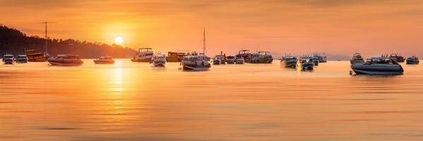 Sonnenuntergang mit buntem Himmel und Boot am Strand
