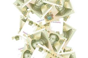 1 chinesische Yuan-Scheine, die einzeln auf Weiß herunterfliegen. viele banknoten fallen mit weißem copyspace auf der linken und rechten seite foto