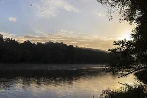 Morgennebel auf der Oberfläche des Flusses foto