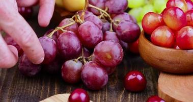 Reißen Sie eine rote Traubenbeere auf dem Tisch ab foto