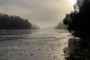 Morgennebel auf der Oberfläche des Flusses foto