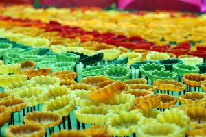 Mehrfarbige Blumen werden aus Kerzen als Hintergrund hergestellt. foto
