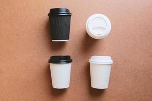 Kaffeetassen aus Papier zum Mitnehmen auf Holzhintergrund für die Markenidentität von Unternehmen, öko-natürliche Pappbecher und Lifestyle-Konzept foto