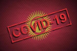kirgisistan-flagge und roter covid-19-stempel. Ausbruch des Coronavirus 2019-ncov foto