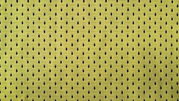 Nahaufnahme von gelben Polyester-Nylon-Gelb-Sporthosen, um einen strukturierten Hintergrund zu schaffen foto