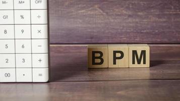 BPM-Geschäftsprozessmanagement auf Holzklötzen und Taschenrechner foto
