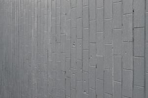 die textur der wand aus den alten fliesen, grau gestrichen unter dem einfluss von kondensation. Viele kleine Tropfen und Wasserflecken an der Wand foto