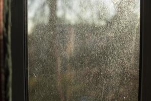 Staub auf Glas. dreckiges fenster am morgen. Oberfläche in feinem Sand. foto