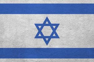 israel-flagge in hellen farben auf alter reliefputzwand dargestellt. strukturierte Fahne auf rauem Hintergrund foto