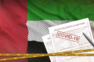 flagge der vereinigten arabischen emirate und antragsformular für die krankenversicherung mit covid-19-stempel. Coronavirus- oder 2019-ncov-Viruskonzept foto