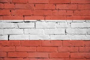 Österreich-Flagge wird auf eine alte Backsteinmauer gemalt foto