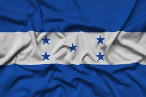Die honduras-Flagge ist auf einem Sportstoff mit vielen Falten abgebildet. Sportteam-Banner foto