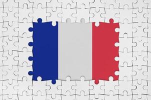 Frankreich-Flagge im Rahmen aus weißen Puzzleteilen mit fehlendem Mittelteil foto