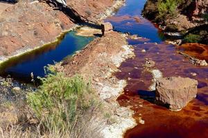 Blick auf die Bergbautätigkeit in Minas de Riotinto in Spanien. verschmutzter fluss, rote und grüne farbe des wassers. Apokalypse Landschaft. Extraktivismus. Bergbaudorf in Andalusien. Zerstörung der Natur. Bergbauindustrie foto