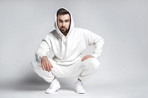 gutaussehender Mann mit leerem weißen Hoodie und Hose foto