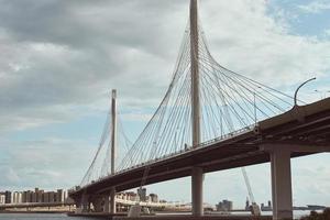 Moderne Schrägseilbrücke über den Fluss gegen bewölkten Himmel foto