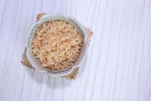brauner Reis in Schüssel isoliert auf weißem Hintergrund foto