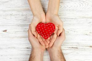 Hilfe, Herz in der Hand auf Holzhintergrund. Valentinstag-Konzept foto