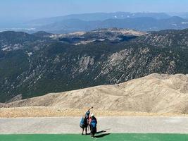 Gleitschirm, der sich darauf vorbereitet, von einem Berg abzuheben foto