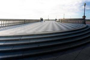 livorno, italien-27. november 2022-menschen, die an einem sonnigen tag auf der mascagni-terrasse spazieren, einer herrlichen belvedere-terrasse mit schachbrettgepflasterter oberfläche, livorno, toskana, italien. foto