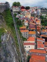 blick auf die steile seilbahn guindais und die historischen malerischen häuser in der nähe des flussufers des douro, die brücke luis i, porto portugal foto