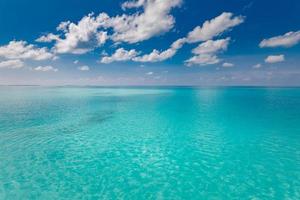 Meer und Himmel. perfektes blaues meerwasser und blauer himmel mit weißen flauschigen wolken, tropischer strandlandschaft und meerblick. horizontaler hintergrund des blauen meeres. Panoramablick foto