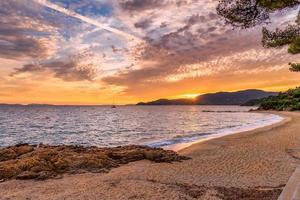 Malerischer Blick auf den Strand von Gigaro in der Bucht von Saint Tropez gegen den dramatischen Himmel bei Sonnenuntergang foto