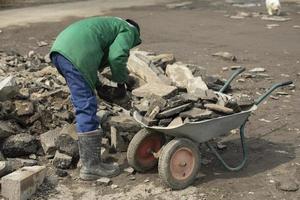 Transport von Steinbruch. Arbeiter baut Steinblock ab. foto