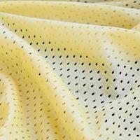 Gelbes Mesh-Sportbekleidungsstoff-Textil-Hintergrundmuster foto
