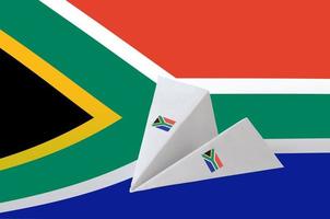 südafrika-flagge dargestellt auf papier-origami-flugzeug. handgemachtes kunstkonzept foto