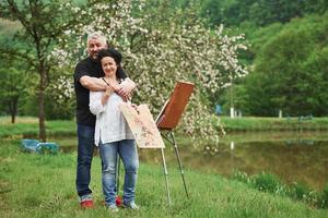 herrliche Natur. reifes paar hat freitage und arbeitet gemeinsam an der farbe im park foto