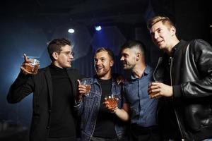 Vorstellung vom Nachtleben. Die Leute haben Spaß im Club. mit Alkohol in den Händen foto