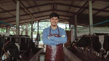 lächelnde und glückliche Bauern auf dem Milchviehbetrieb. landwirtschaftsindustrie, landwirtschafts- und tierhaltungskonzept, kuh auf milchfarm, die heu frisst. foto