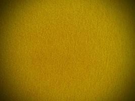 Filz gelb weich rau Textilmaterial Hintergrundtextur Nahaufnahme, Pokertisch, Tennisball, Tischdecke. leerer gelber Stoffhintergrund. foto