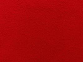 Filz rot weich rau Textilmaterial Hintergrundtextur Nahaufnahme, Pokertisch, Tennisball, Tischdecke. leerer roter Stoffhintergrund. foto